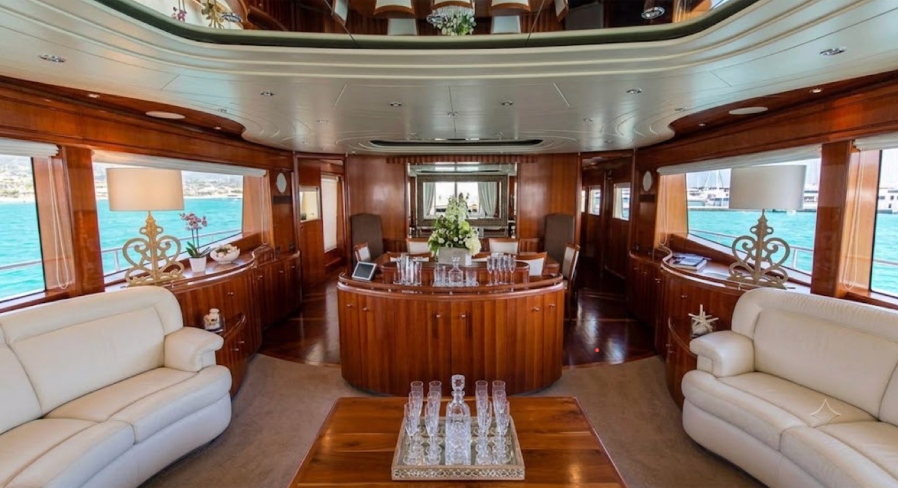 Main saloon with cream leather seating and polished wood